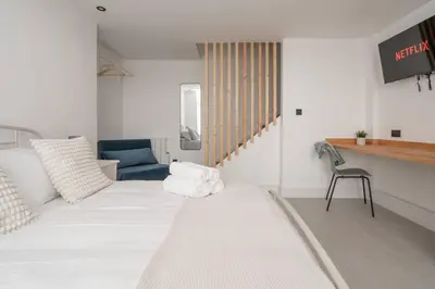 a room with a bed with towels on it at Cosy Nook Kitchen w Washer & SofaBed Parking in Liverpool