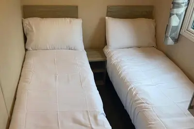 two beds sitting next to each other in a room at Seaside Retreat-Sleeps 8-Free Parking in Morecambe