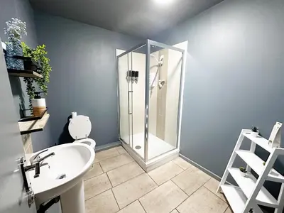 a bathroom with a shower and a toilet and a sink at Oak Suite - 2 Bed - Sleeps 4 - Central Blackpool in Blackpool