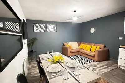 a living room with a table and a couch at Oak Suite - 2 Bed - Sleeps 4 - Central Blackpool in Blackpool