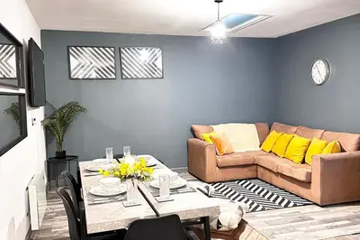 a living room with a couch and a table with yellow pillows at Oak Suite - 2 Bed - Sleeps 4 - Central Blackpool in Blackpool
