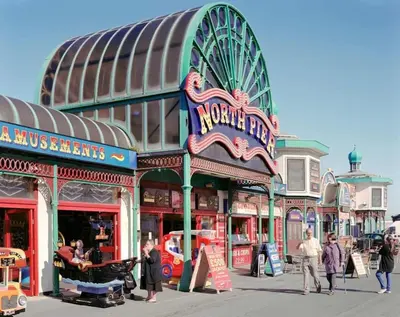 a street with people walking in front of a building at Oak Suite - 2 Bed - Sleeps 4 - Central Blackpool in Blackpool