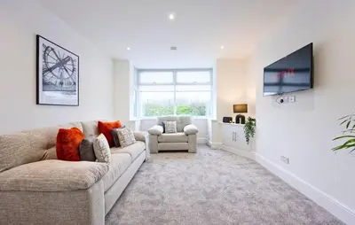 a living room with a couch and a chair at 3 Bed House, Free Parking, Garden in Ince-in-Makerfield