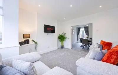 a living room with two couches and a tv at 3 Bed House, Free Parking, Garden in Ince-in-Makerfield
