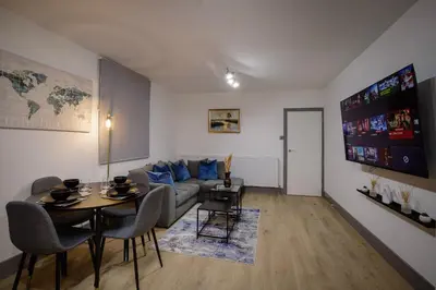 a living room with a couch and a table at 2 Bedroom, 1 Bathroom apartment in Blackpool