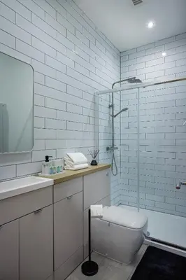a white bathroom with a toilet and a sink at 2 Bedroom, 1 Bathroom apartment in Blackpool