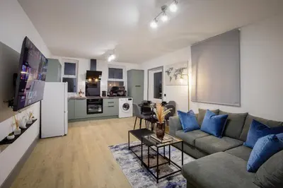 a living room with a couch and a kitchen at 2 Bedroom, 1 Bathroom apartment in Blackpool