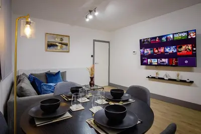 a living room with a table and a couch at 2 Bedroom, 1 Bathroom apartment in Blackpool