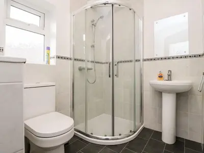 a bathroom with a shower and a toilet and a sink at Lytham House in Lytham St Annes