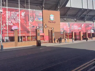 a large building with people walking on a street at Anfieldstadiumroomz in Liverpool