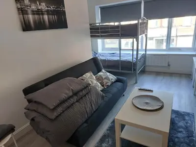 a living room with a couch and a bunk bed at Anfieldstadiumroomz in Liverpool