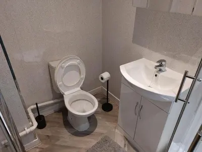 a bathroom with a white toilet and a sink at Anfieldstadiumroomz in Liverpool