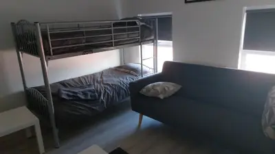 a living room with a bunk bed and a couch at Anfieldstadiumroomz in Liverpool