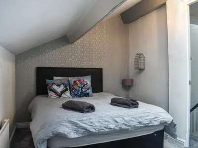 a bedroom with a bed with two pillows on it at Nelson House in Clitheroe