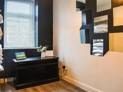 a room with a black desk and a window at Nelson House in Clitheroe