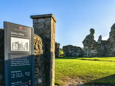 a sign in front of an old castle at Nelson House in Clitheroe