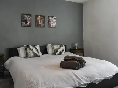 a bedroom with a large white bed with two pillows at Nelson House in Clitheroe