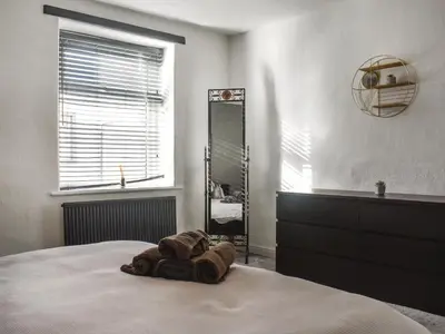 a bedroom with a bed with a towel on it at Nelson House in Clitheroe