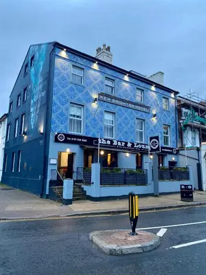 a blue building on the side of a street at The New Brighton Hotel in New Brighton