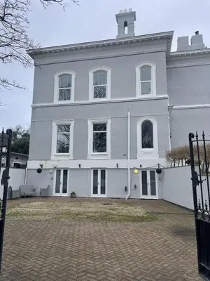 a large white building with a tower on top at Beach House Courtyard 2 bed in Southport