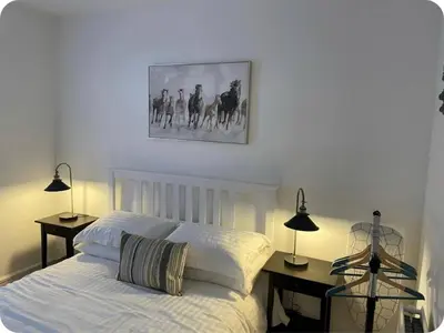 a bedroom with a bed with two lamps and a picture on the wall at Beautiful six bedroom townhouse citybreak close to city centre in Liverpool