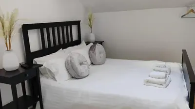 a bedroom with a white bed with pillows on it at Beautiful six bedroom townhouse citybreak close to city centre in Liverpool