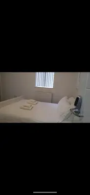 a bedroom with a bed with a phone on it at Beautiful six bedroom townhouse citybreak close to city centre in Liverpool