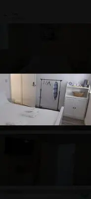 a small white kitchen with a stove top oven at Beautiful six bedroom townhouse citybreak close to city centre in Liverpool