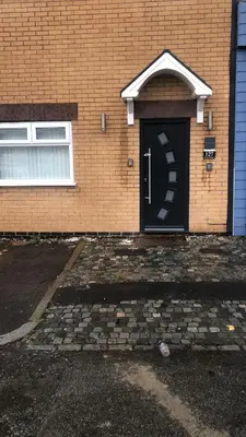 a black door on a brick building with a window at Beautiful six bedroom townhouse citybreak close to city centre in Liverpool