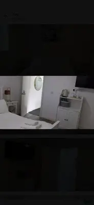 a small bedroom with a bed and a kitchen at Beautiful six bedroom townhouse citybreak close to city centre in Liverpool
