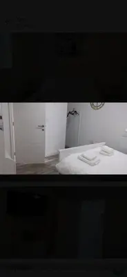 a bedroom with a white bed and a white cabinet at Beautiful six bedroom townhouse citybreak close to city centre in Liverpool