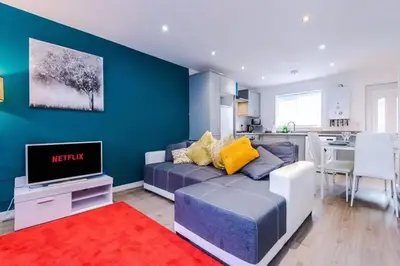 a living room with a couch and a tv at Blissful Luxury Home in Liverpool