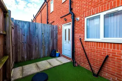 a brick house with a door and a fence at Blissful Luxury Home in Liverpool