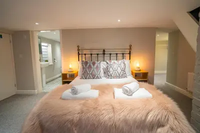 a bedroom with a large bed with two pillows at Birkdale Retreat in Southport