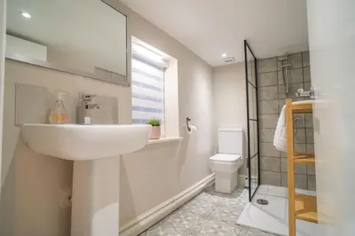 a bathroom with a sink and a toilet at Birkdale Retreat in Southport