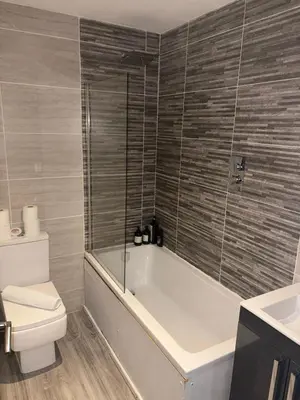 a bathroom with a tub and a toilet and a sink at CASTLE STREET - City Centre 2 bedroomed Apt sleeps 8 in Liverpool