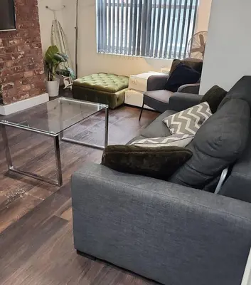 a living room with a couch and a glass table at CASTLE STREET - City Centre 2 bedroomed Apt sleeps 8 in Liverpool