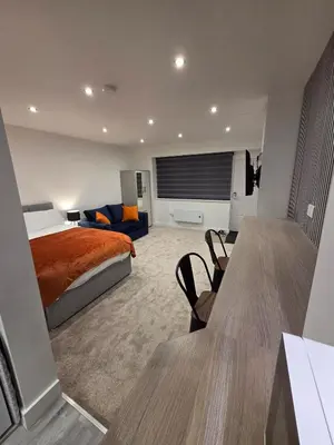 a hotel room with a bed and a couch at Modern Studio Apartment in Blackburn Town Centre in Blackburn