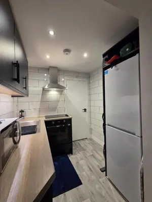 a kitchen with a black and white refrigerator at Modern Studio Apartment in Blackburn Town Centre in Blackburn