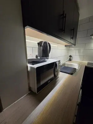 a microwave sitting on a counter in a kitchen at Modern Studio Apartment in Blackburn Town Centre in Blackburn