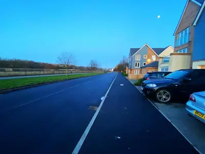 an empty street with cars parked on the side at Small Double Room in Lancaster Riverside - 15 Minutes Walk to City Centre in Torrisholme
