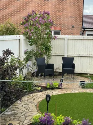 a patio with two chairs and a tree in a garden at Small Double Room in Lancaster Riverside - 15 Minutes Walk to City Centre in Torrisholme