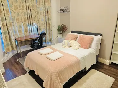 a bedroom with a bed with two towels on it at Room 1 Shared House in Bootle in Litherland