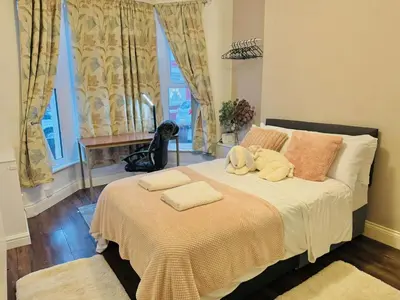 a bedroom with a bed with two stuffed animals on it at Room 1 Shared House in Bootle in Litherland