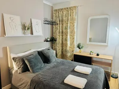 a bedroom with a bed with two towels on it at Room 3 Shared House in Bootle in Litherland
