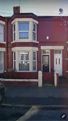 a red brick building with a white window at Room 3 Shared House in Bootle in Litherland