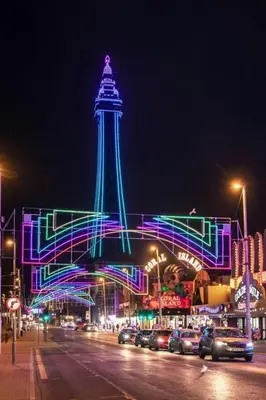 a tower lit up at night with cars parked at Willow Suite - 3br - Sleeps 8 - Central Blackpool in Blackpool