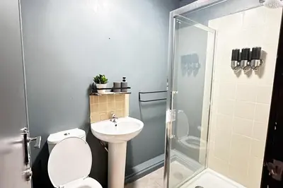 a bathroom with a toilet and a sink and a shower at Willow Suite - 3br - Sleeps 8 - Central Blackpool in Blackpool
