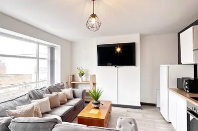 a living room with a couch and a table at Willow Suite - 3br - Sleeps 8 - Central Blackpool in Blackpool