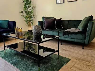 a living room with a green couch and a table at Falkner Square in Liverpool